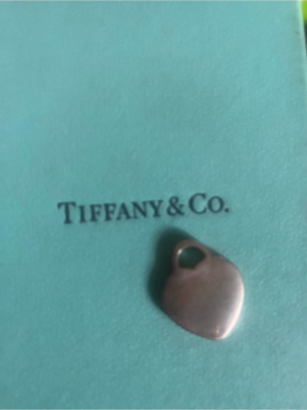 Tiffany & Co. Heart Charm Pendant on Tiffany Blue Backdrop
